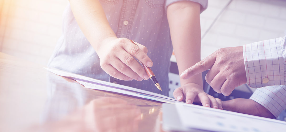 Hands pointing to papers