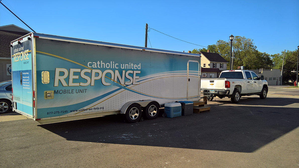 Catholic United Response mobile unit driving down the street.