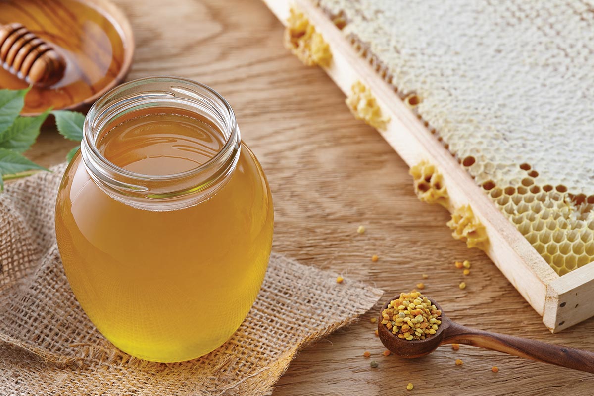 Country honey stand with honey jar and comb