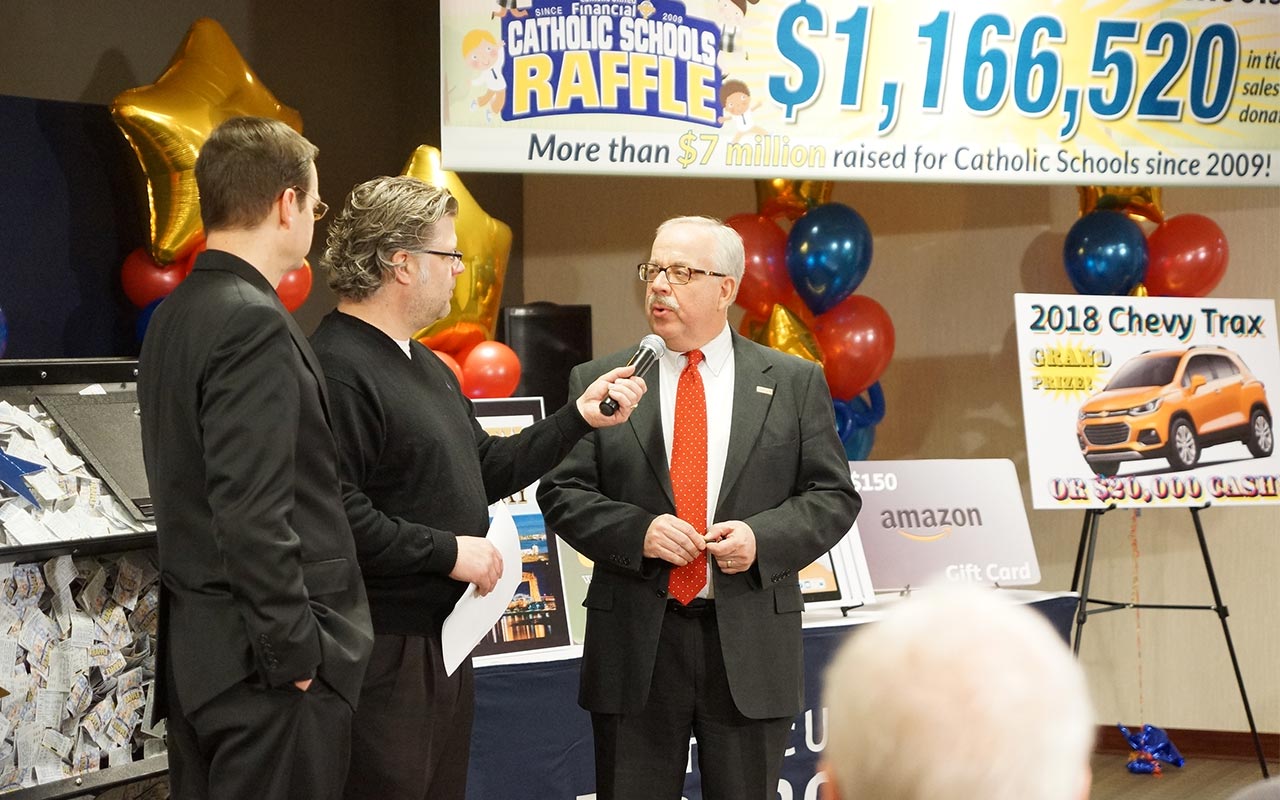 Radio personality "The Rookie" from AM 1500 interviews Harald Borrmann, President of Catholic United Financial on air during the prize ceremony on March 7th with Father John Ubel of the Cathedral of St. Paul.