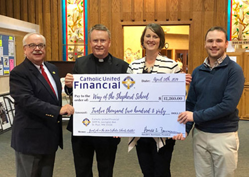 PResident Borrmann with leaders from a 2019 Catholic Schools Raffle School