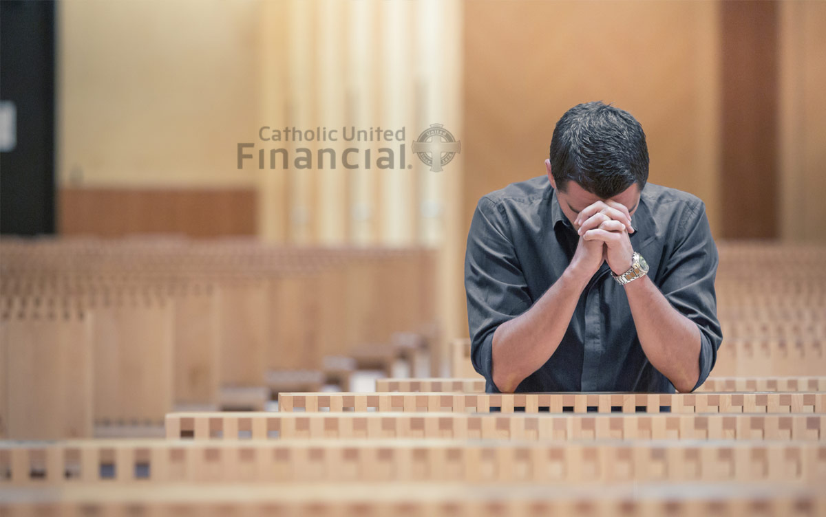 Young man praying in a modern sanctuary