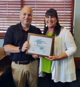 President Michael Ahles and Denise Degerstrom celebrate her new award from NAFIC