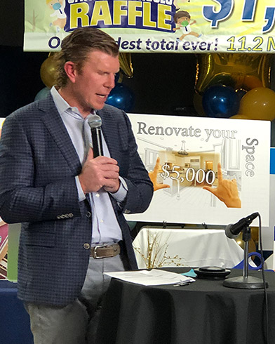 Ceremony Emcee Matt Birk talks on speakerphone to Jolene Olson of Buffalo, MN to inform her she won the grand prize of a new Ford Ecosport SUV or $20,000 cash.