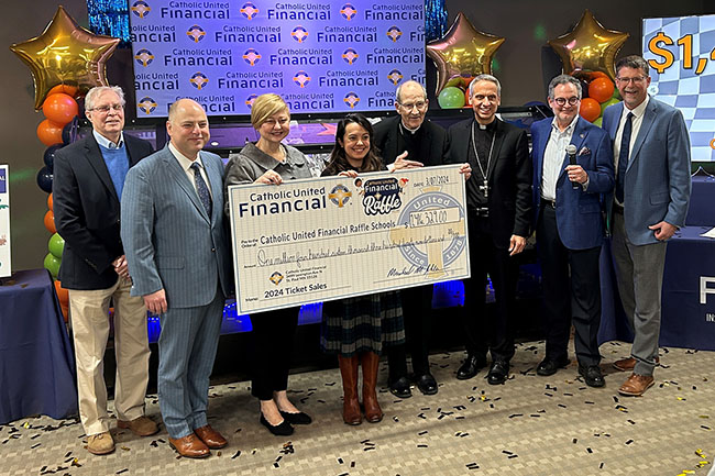 Audience members celebrate the success of the 2024 Catholic United Financial Raffle.