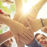 Members with hands in a circle