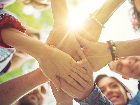 Members with hands in a circle