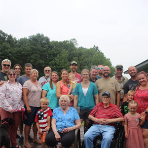 Large family photo on deck of family home