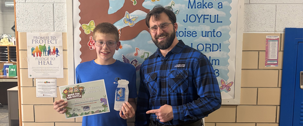 20260918_RaffleDesktop2_1200x500 Student at Sacred Heart School in Adams, Minnesota receiving an award.
