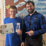 Student at Sacred Heart School in Adams, Minnesota receiving an award.