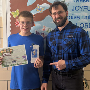 Student at Sacred Heart School in Adams, Minnesota receiving an award.